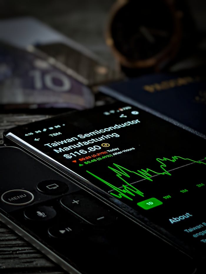 Smartphone with stock market graph showing Taiwan Semiconductor Manufacturing data.